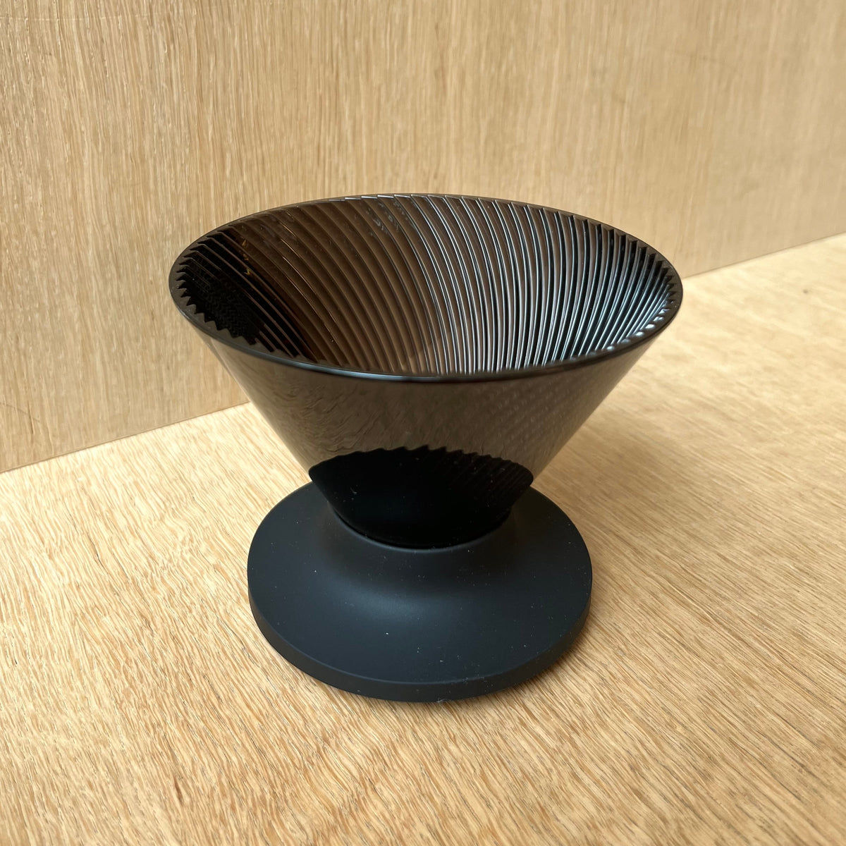 HARIO V60 NEO black dripper on wooden surface for precision coffee brewing