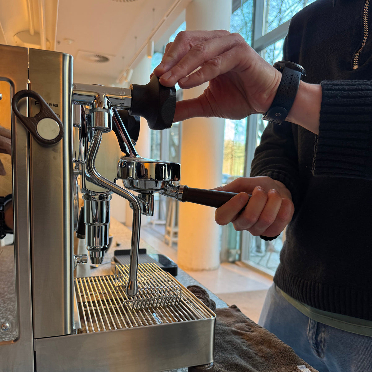 Image of hands operating an espresso machine for an OFFICE COFFEE SUBSCRIPTION coffee experience.