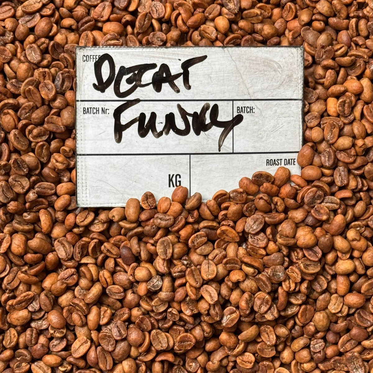 DECAF FUNKY coffee beans with batch label, showcasing vibrant Colombian flavor and specialty decaffeinated coffee.