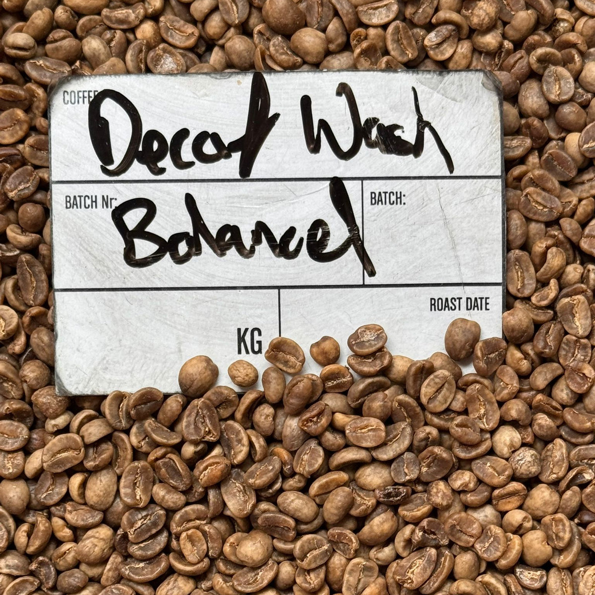 DECAF BALANCED coffee label on roasted beans, highlighting the balanced flavor profile of the decaf batch.
